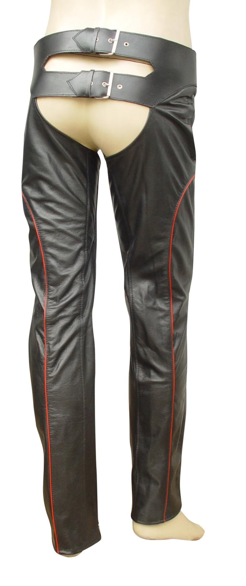 May include: Black leather chaps with red stitching along the sides. The chaps feature a wide belt with two silver buckles. The garment is designed to be worn over other clothing, offering protection and style.