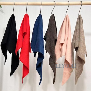 May include: Six triangular scarves hanging on a wooden rod, each suspended by a metal hook. The scarves are in black, red, blue, dark brown, light pink, and beige. The text LEYOOLI is printed in blue on the light pink scarf.