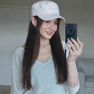 May include: A light beige military-style cadet cap with a flat top and a curved brim. The cap features a structured crown and a simple, solid-coloured fabric design. The word LEYOOLI is printed in a small, clear font on the lower right side of the image.