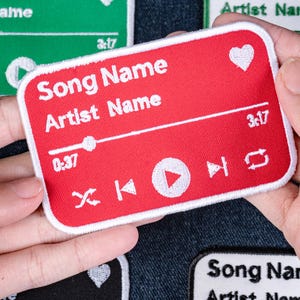 May include: A rectangular red embroidered patch featuring white stitched text that reads Song Name and Artist Name. The design includes a heart icon, a progress bar with a playhead, a timestamp of 0:37 and 3:17, and media playback control icons.