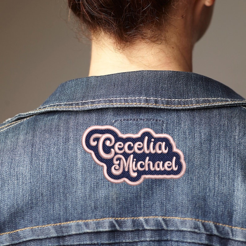 May include: A denim jacket with a pink and blue embroidered patch that says "Cecelia Michael"