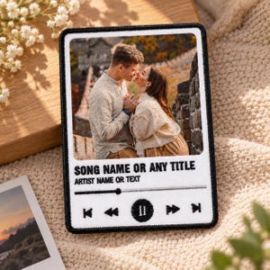 May include: A rectangular embroidered patch featuring a custom photograph of a couple in a landscape. Below the image, the text reads SONG NAME OR ANY TITLE and ARTIST NAME OR TEXT, followed by a playback progress bar and music control icons.