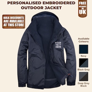 May include: A navy blue hooded outdoor jacket with a fleece lining. The jacket has a zip closure and two pockets. The text "YOUR TEXT HERE" is embroidered on the right side of the jacket. The jacket is available in navy, black grey, and deep grey black.
