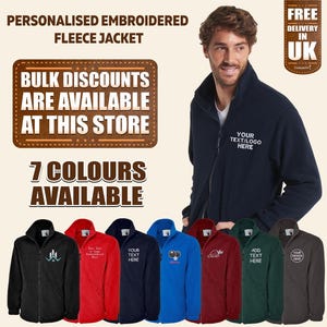May include: A navy blue fleece jacket with a zip fastening and a stand-up collar. The jacket features a personalised embroidered design that reads "Your Text/Logo Here". The image displays seven different colour options for the jacket: black, red, navy blue, royal blue, burgundy, green, and grey.