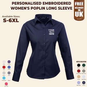May include: Navy blue poplin long-sleeve shirt with a button-down collar. The shirt has the text "YOUR TEXT HERE" embroidered on the chest. Available in sizes S-6XL and various colours, including black, burgundy, and navy.
