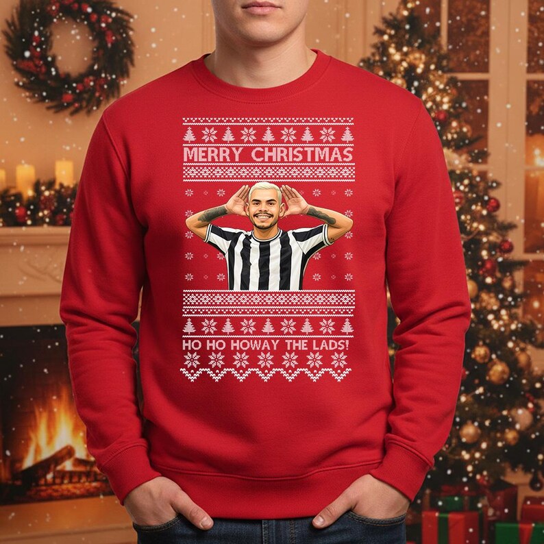 May include: Red Christmas sweater with a festive design. The sweater features a portrait of a person in a black and white striped shirt, with the text "MERRY CHRISTMAS" and "HO HO HOWAY THE LADS!" in white.