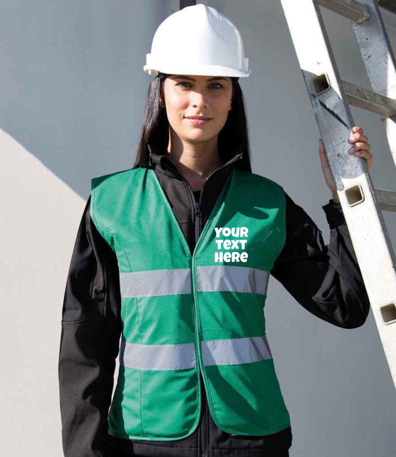 May include: A green safety vest with reflective strips and a white zipper. The vest has the text "YOUR TEXT HERE" printed on the front.