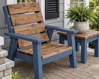 May include: A wooden chair and a matching side table featuring a blue painted frame and natural brown stained horizontal wood slats. The chair has a slanted backrest and wide armrests, while the side table holds a potted green fern plant.