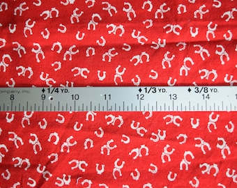 1 yard red cotton fabric with tiny white horse shoes.