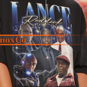 May include: Black oversized t-shirt with a graphic print of five men. The graphic features the text "Lance Redlich" and "GnoxCo".