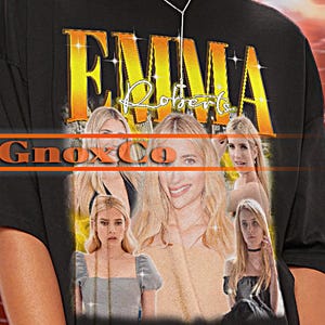 May include: Black oversized t-shirt with a graphic print of Emma Roberts and the text "Emma Roberts" and "GnoxCo".