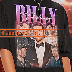 May include: Black unisex t-shirt with a graphic print of a band called "Billy Eichner" and the text "Ginox Co."