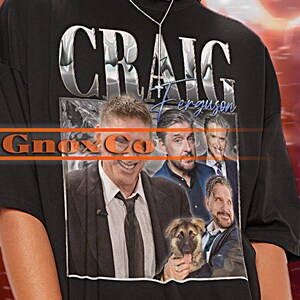 May include: Black unisex t-shirt with a graphic print of a man's face and the text "CRAIG Ferguson" in white letters. The shirt is oversized and the model is wearing a 2XL size.