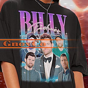 May include: Black t-shirt with a graphic print of a band called "Billy Eichner" with a purple and blue gradient. The band members are wearing suits and casual clothing. The text "GnoxC0" is printed below the band name.