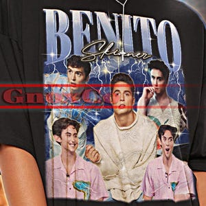 May include: Black unisex t-shirt featuring a graphic of a man's face and the text "BENITO". The shirt also has the text "TSHIRT Unisex" at the top. The shirt is a 2XL size.