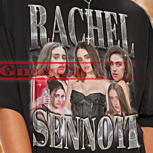May include: Black unisex t-shirt with the text "RACHEL SENNOTT" in silver lettering. The shirt features a graphic of several women. The words "TSHIRT Unisex" are at the top.
