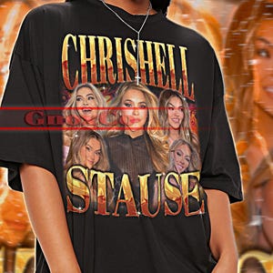 May include: Black unisex t-shirt with the text "CHRISHELL STAUSE" in gold lettering. The shirt features a collage of women's faces. The words "TSHIRT Unisex" are at the top. The model is wearing the shirt.