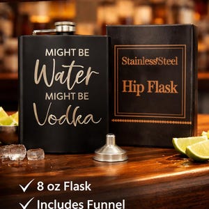 May include: A black stainless steel hip flask with the text "Might Be Water, Might Be Vodka". The flask is 237 ml and includes a funnel. The gift box is also visible.
