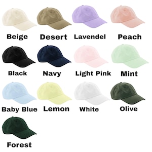 May include: A collection of baseball caps in various colors, including beige, desert, lavender, peach, black, navy, light pink, mint, baby blue, lemon, white, olive, and forest green. Each cap has a curved brim and adjustable strap.