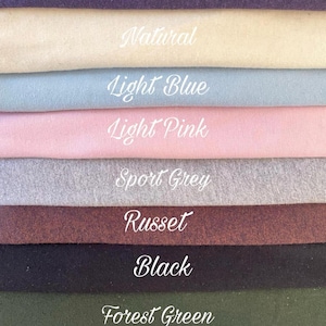 May include: A color palette featuring fabric swatches in various shades. The colors include Blackberry, Natural, Light Blue, Light Pink, Sport Grey, Russet, Black, Forest Green, and White. Each swatch has its color name written in cursive.