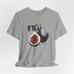 May include: Gray t-shirt with a graphic of two figs, one whole and one cut open, with the word "FIG" printed above them. The text "Figs carica" is printed below the figs.
