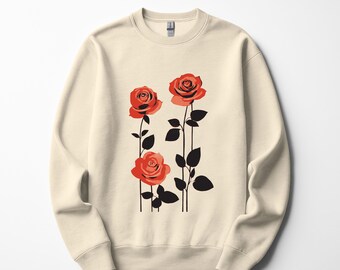 Könnte beinhalten: Cremefarbenes Sweatshirt mit einer Grafik von drei roten Rosen. Die Rosen haben schwarze Stiele und Blätter. Das Design ist auf der Vorderseite des langärmligen Oberteils mit Rundhalsausschnitt zentriert. Die Rosen blühen voll, mit detaillierten Blütenblättern.