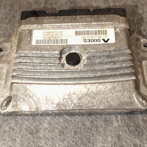 May include: A silver automotive control unit with black connectors and a label that reads "21585470-4A 50255 019514 R2001258372 0200187138 S3000" and "JOHNSON CONTROLS".
