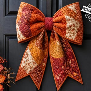 May include: A large, quilted bow in autumnal colors hangs on a black door. The bow features a patchwork design with shades of orange, red, and cream. The text "INSTANT DOWNLOAD" is in a white circle on the upper right.