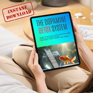 May include: A tablet displaying "The Dopamine Detox System" with text about reclaiming attention and reducing screen time. A goldfish swims in a bowl with a smartphone inside. The image includes a red "Instant Download" stamp.