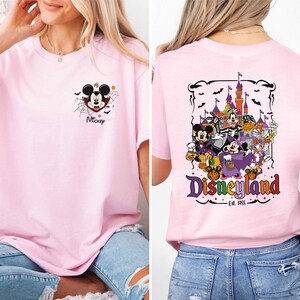 The image is a collage of two photos featuring a woman wearing a pink t-shirt with a Disney-themed design. The back of the t-shirt displays a colorful graphic of Mickey Mouse and various Disney characters, along with the text "Disneyland" and "Est. 1955".