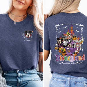 The image is a collage of two photos of a woman wearing a blue t-shirt with a Disney-themed design. The back of the t-shirt features a colorful graphic of Disney characters and the text "Disneyland" along with the year "Est. 1955".