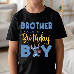 a young boy wearing a black shirt with the words brother of the birthday boy on