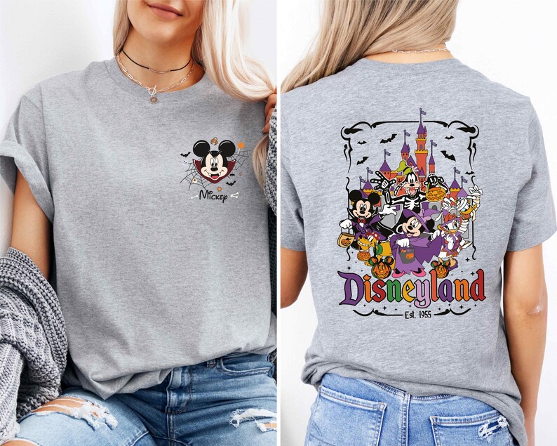 A woman wearing a gray t-shirt with a Disney-themed graphic on the back.