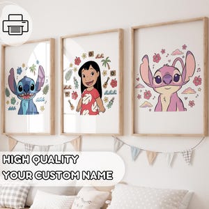 May include: Three framed art prints featuring characters from a popular animated film. The prints showcase Stitch, Lilo, and Angel, surrounded by tropical elements. The frames are light brown, and the prints are displayed on a white wall.