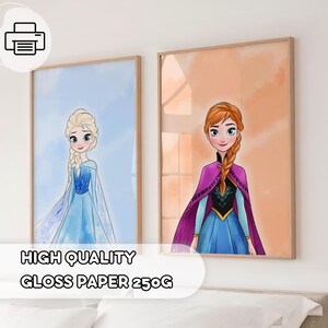May include: Two framed art prints featuring illustrations of animated characters. One print shows a character in a blue dress with blonde hair, set against a blue background. The other print depicts a character in a purple cape and blue dress, set against an orange background.
