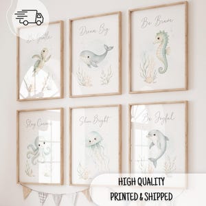May include: Six framed wall art prints featuring watercolor sea creatures including a turtle, whale, seahorse, octopus, jellyfish, and dolphin. Each print includes text: Be Gentle, Dream Big, Be Brave, Stay Curious, Shine Bright, and Be Joyful.