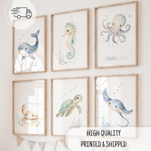 May include: A set of six framed wall art prints featuring watercolor illustrations of a whale, seahorse, octopus, crab, sea turtle, and stingray. Each print displays a marine animal in soft blue and beige tones with bubbles on a white background.