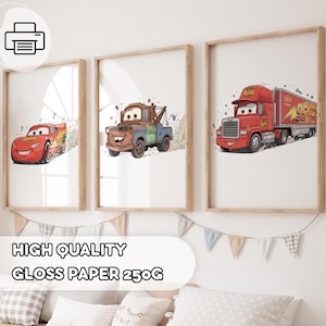May include: Three framed prints featuring cartoon cars. The first print shows a red race car, the second a brown tow truck, and the third a red semi-truck. The prints are displayed on a white wall above a bed with pillows and a banner.