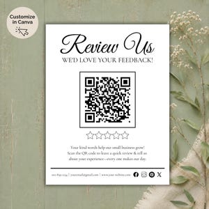 May include: A white rectangular sign with the words "Review Us" in elegant script. It features a QR code, star ratings, and text encouraging reviews. The sign is set against a soft green background with floral accents.