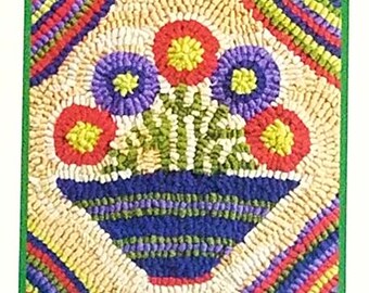 May include: A colorful rug with a floral design. The rug features a blue vase with red, purple, and yellow flowers. The rug is surrounded by a green border.