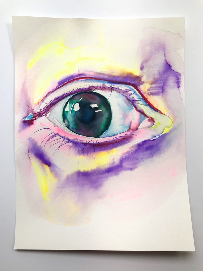May include: A close-up watercolor painting of a human eye. The eye is green with a black pupil and is surrounded by pink and purple watercolor washes.