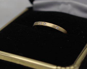 14 Karat Yellow Gold Band With Scattered Flush Set Diamonds