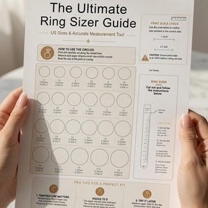 May include: A white paper ring sizer guide titled The Ultimate Ring Sizer Guide with US sizes and accurate measurement tools. It features rows of circles with corresponding measurements in inches and millimetres, plus a cut-out ring sizer strip.