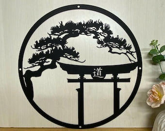 May include: Black metal wall art featuring a silhouette of a Japanese pine tree and a torii gate with the kanji "道" (pronounced "dō") meaning "the way" or "the path".