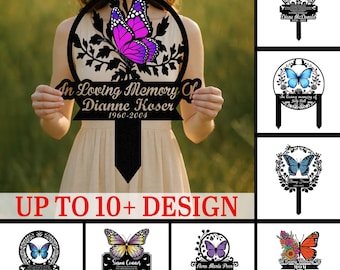 Può includere: Un paletto commemorativo in metallo nero con un design a farfalla e la scritta "In Loving Memory Of Dianne Koser 1960-2004". L'immagine mostra anche altri paletti commemorativi con disegni a farfalla e nomi.
