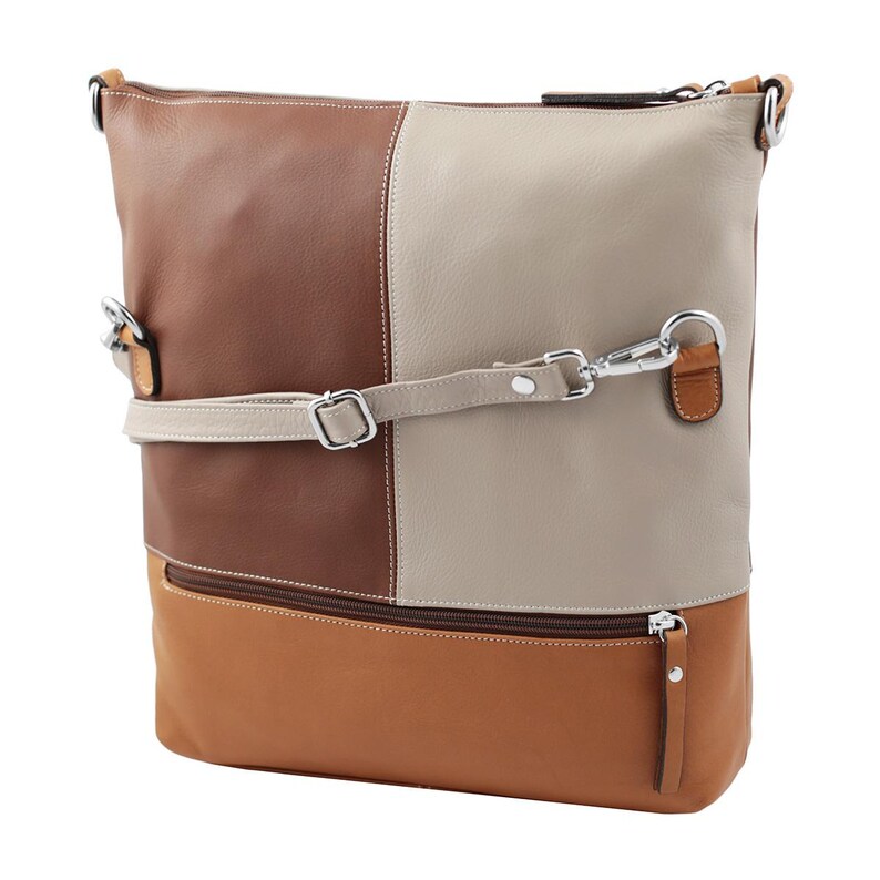Modern leather handbag with a stylish color-block design in brown, beige, and tan tones. This spacious women’s bag features an adjustable strap, silver hardware, and a front zipper pocket, perfect for an everyday tote or crossbody purse.
