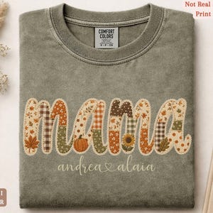 Personalized Mama Comfort Colors shirt with custom kids names, fall patchwork letters, pumpkins, florals, and faux embroidery effect in warm autumn tones on a khaki tee.