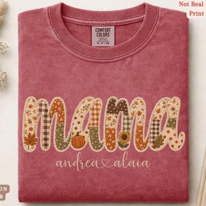 Personalized Mama Comfort Colors shirt with custom kids names, fall patchwork letters, pumpkins, florals, and faux embroidery effect in warm autumn tones on a crimson tee.