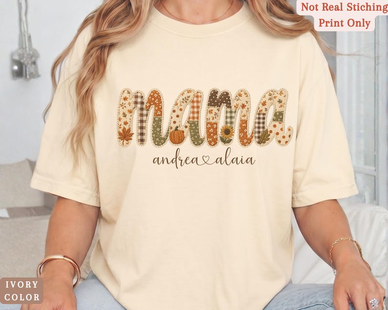 Personalized Mama Comfort Colors shirt with custom kids names, fall patchwork letters, pumpkins, florals, and faux embroidery effect in warm autumn tones on an ivory tee.