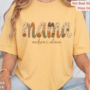 Personalized Mama Comfort Colors shirt with custom kids names, fall patchwork letters, pumpkins, florals, and faux embroidery effect in warm autumn tones on a butter tee.